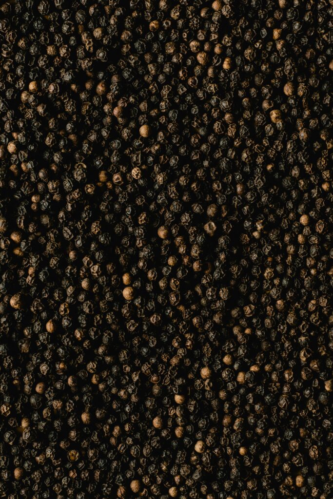 Detailed close-up of black peppercorns showcasing texture and spice quality.